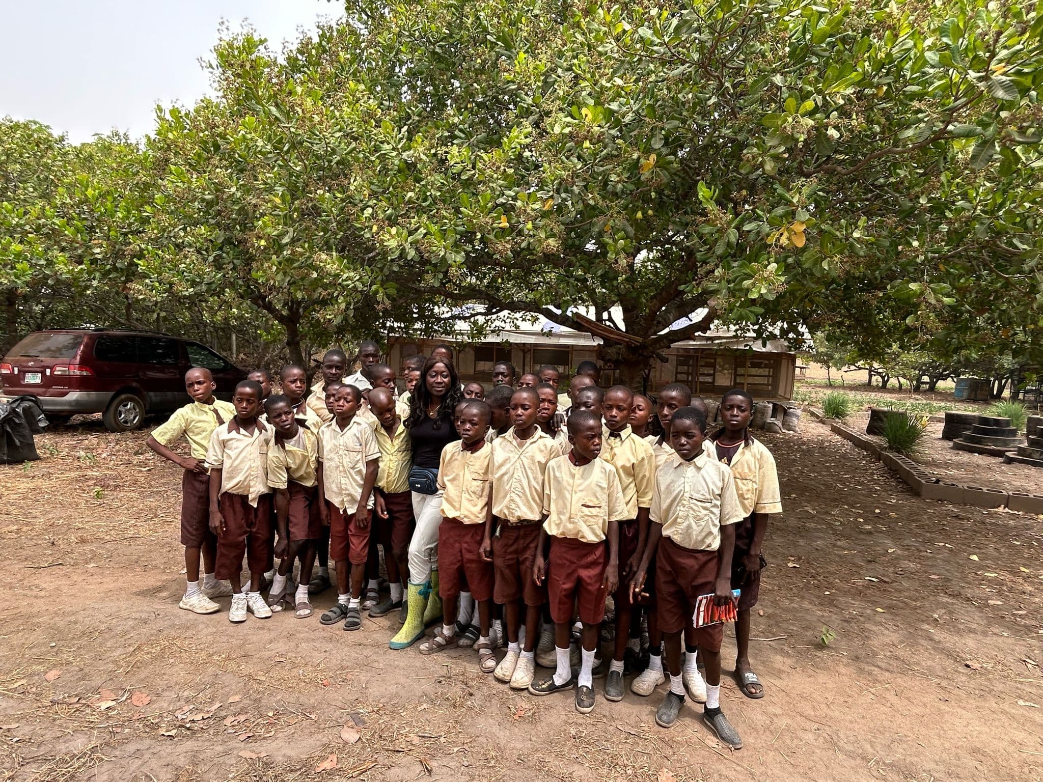 Secondary-school students visiting Maripha Farms under the cashew trees